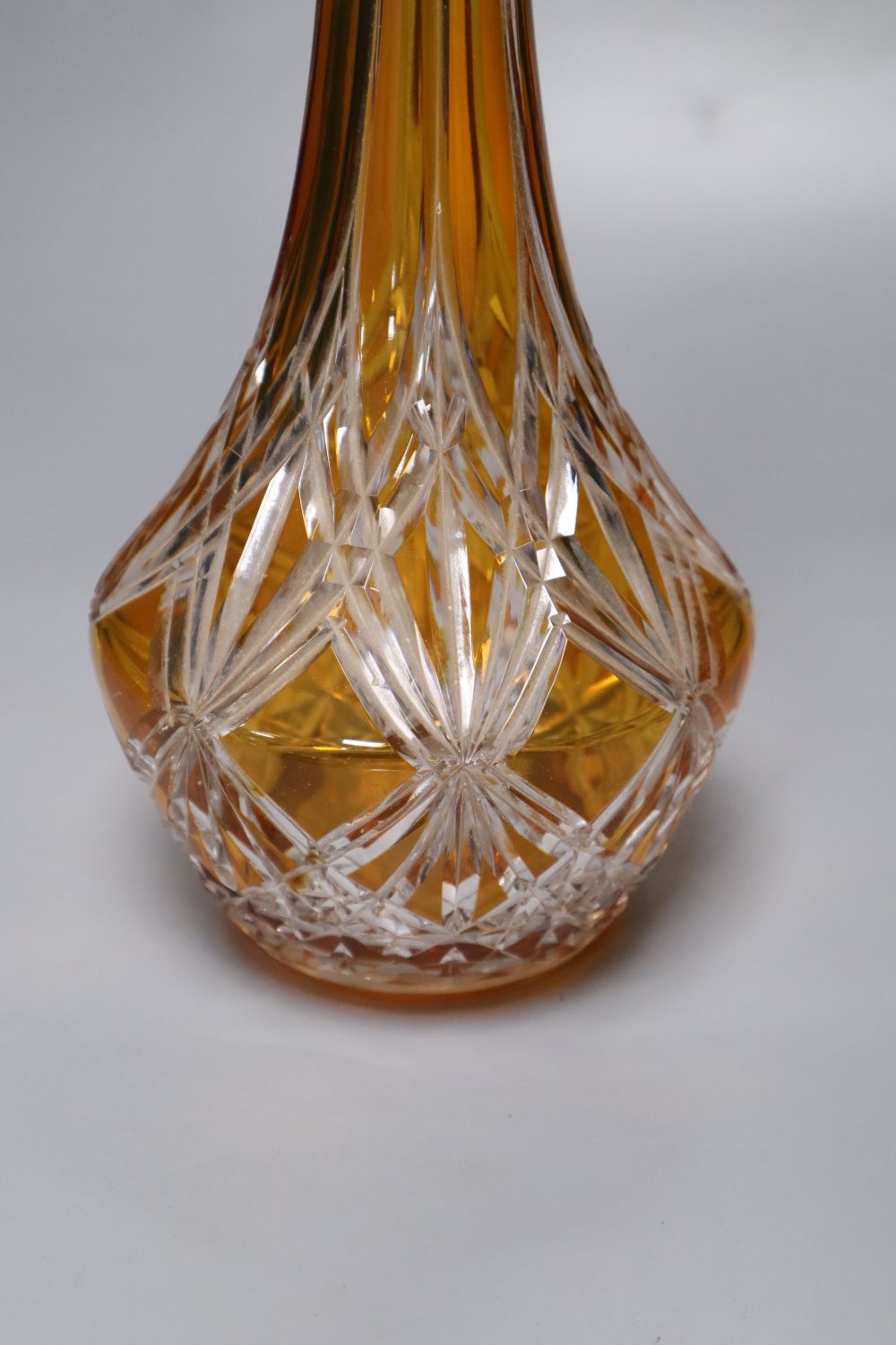 A tall amber-flashed glass decanter and clear stopper, height 48cm